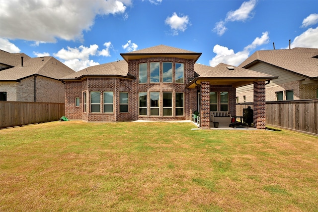 back of house featuring a yard and a patio