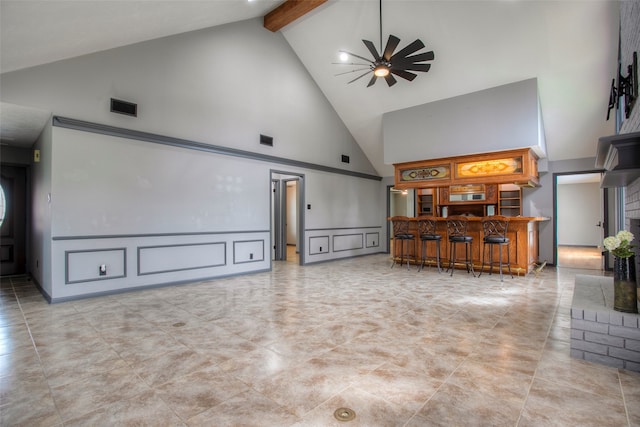 living room with beamed ceiling, a brick fireplace, high vaulted ceiling, and ceiling fan