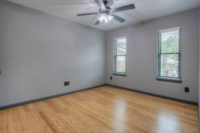 empty room with light wood-style flooring, baseboards, and a ceiling fan