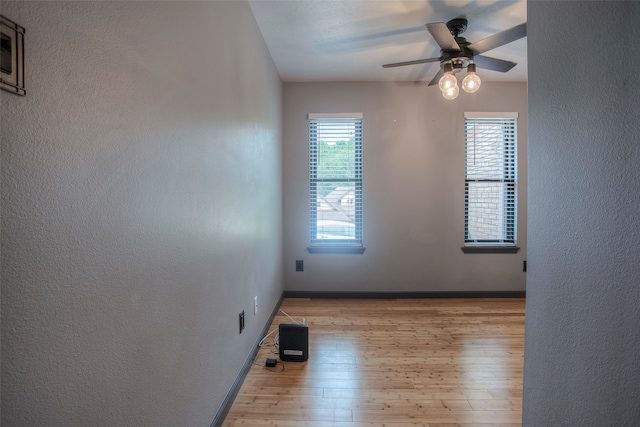 unfurnished room featuring ceiling fan and light hardwood / wood-style flooring