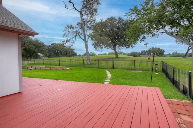 deck with a yard and a rural view