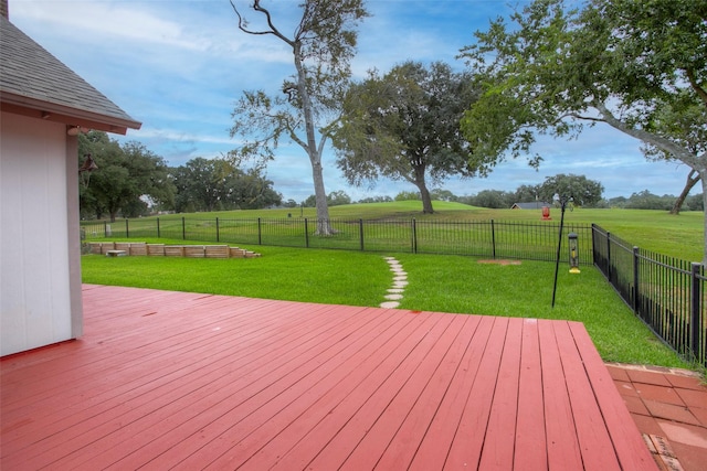 deck featuring a yard, a rural view, and a fenced backyard