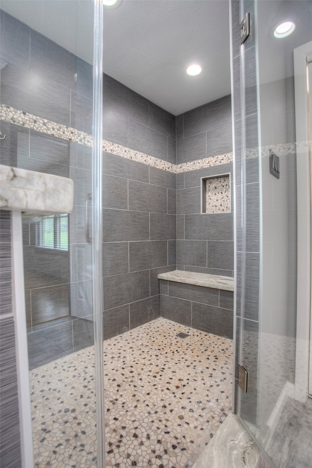 bathroom with a shower with door