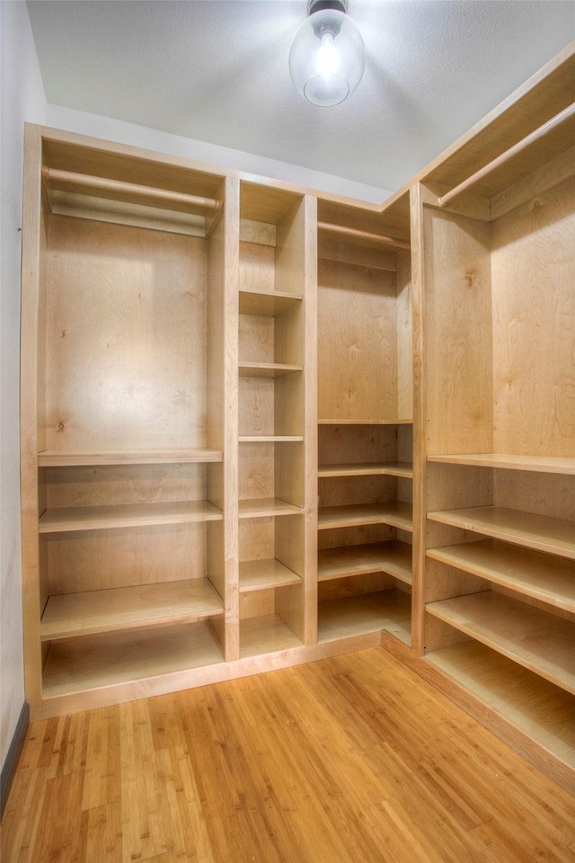 walk in closet featuring wood finished floors