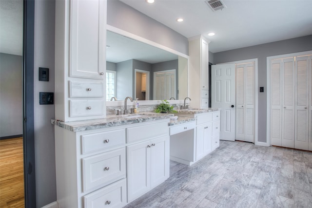 bathroom with hardwood / wood-style flooring and vanity