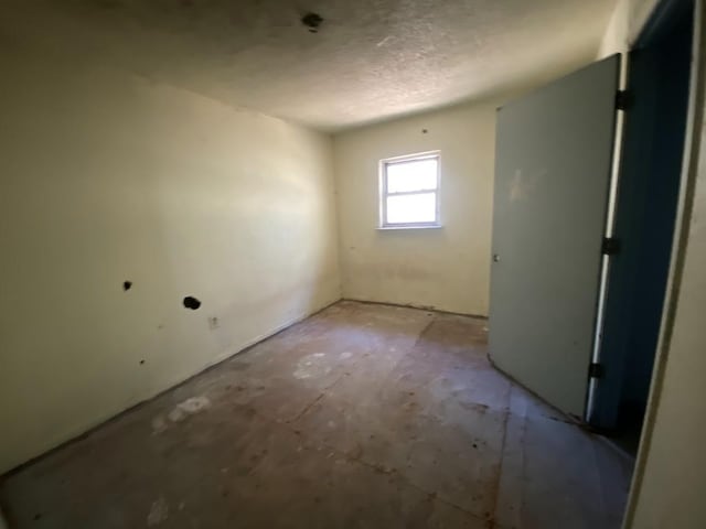 empty room featuring a textured ceiling