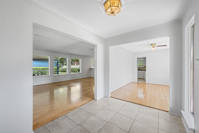 interior space with ornamental molding, light tile patterned floors, and ceiling fan