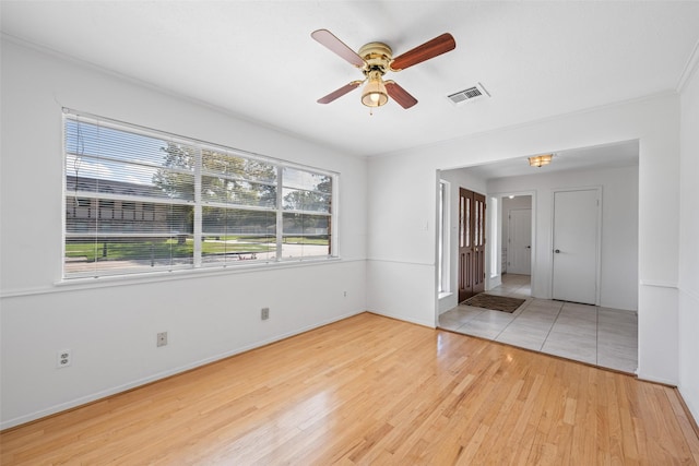 spare room featuring ceiling fan and light wood-type flooring