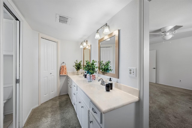 bathroom with ceiling fan, vanity, and toilet