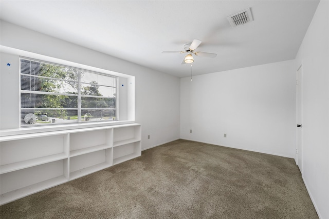 carpeted empty room featuring ceiling fan