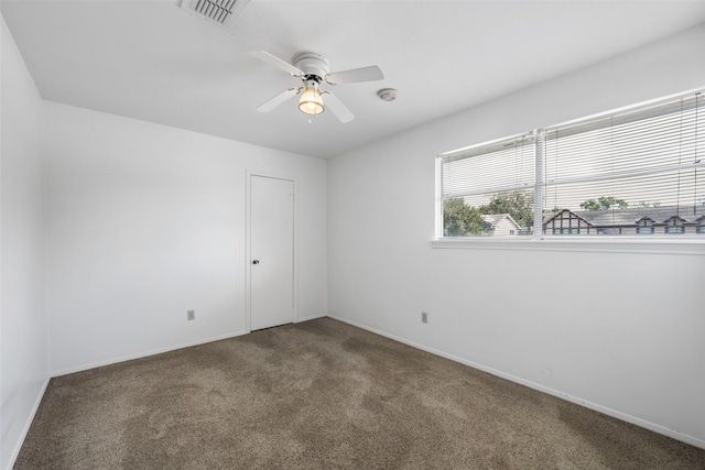 empty room with ceiling fan and carpet floors