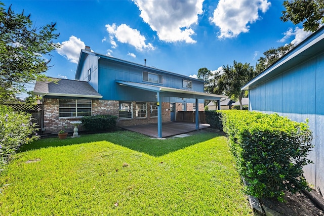 back of property with a lawn and a patio