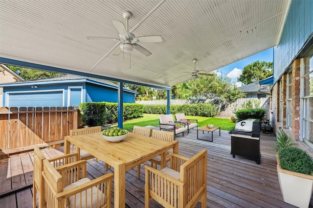 wooden deck featuring outdoor lounge area, a yard, grilling area, and ceiling fan