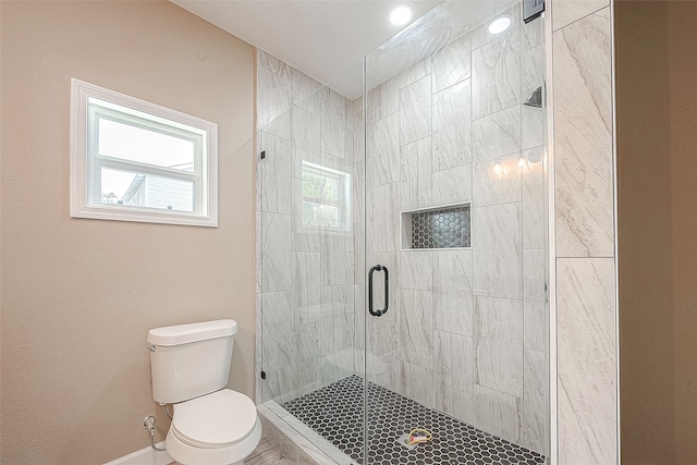 bathroom with a shower with door and toilet