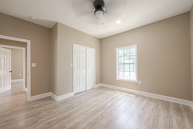 unfurnished bedroom featuring ceiling fan, a closet, and light hardwood / wood-style floors