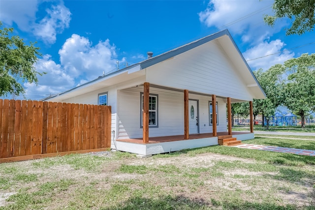 view of home's exterior featuring a yard and a porch