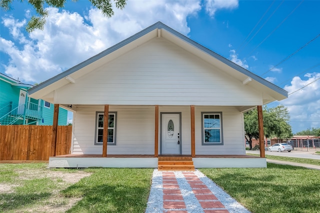 bungalow-style house featuring a porch and a front lawn