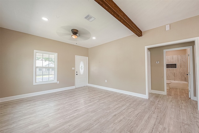 empty room with ceiling fan, beamed ceiling, and light hardwood / wood-style floors