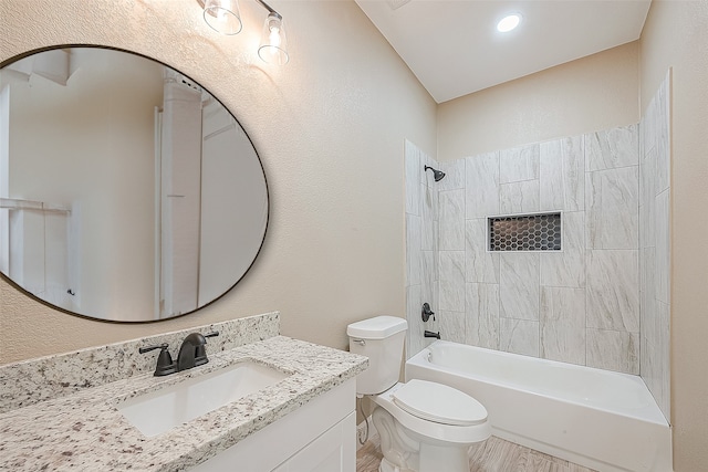 full bathroom with tiled shower / bath combo, vanity, and toilet