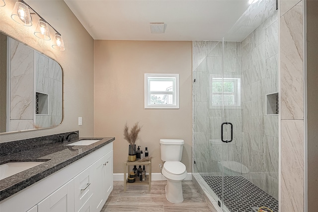 bathroom with walk in shower, wood-type flooring, vanity, and toilet