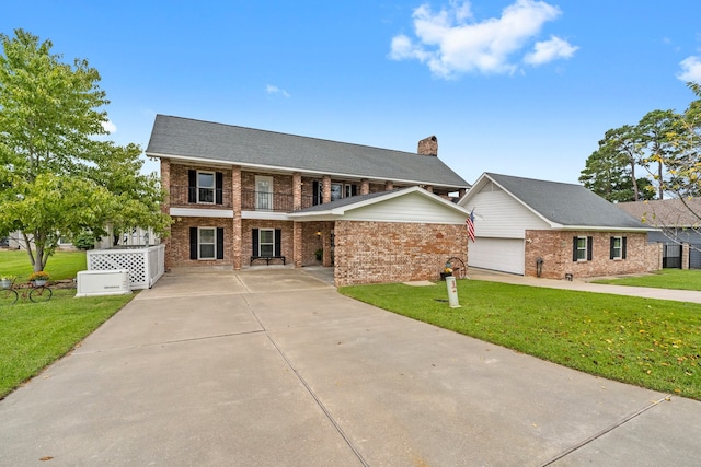 view of front of house featuring a front yard, a garage, and a balcony