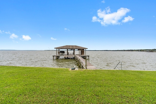 dock area with a yard and a water view