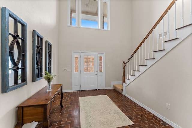 entrance foyer featuring a wealth of natural light and a high ceiling