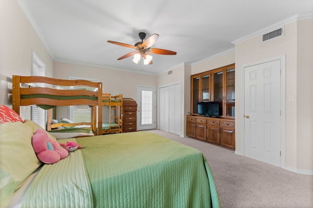 carpeted bedroom with ornamental molding and ceiling fan