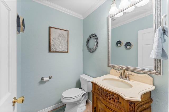 bathroom featuring vanity, crown molding, toilet, and tile patterned floors