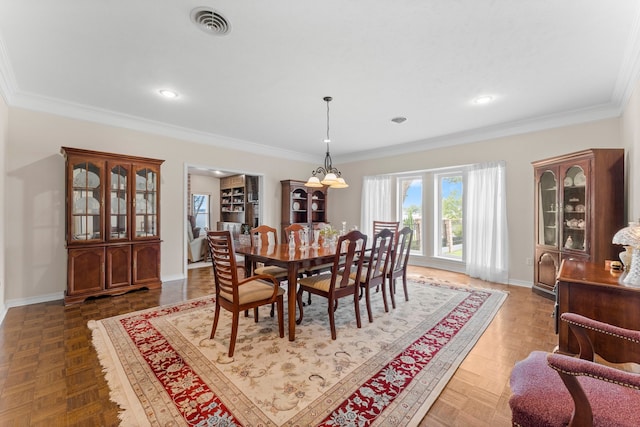 dining room with crown molding, a notable chandelier, and dark parquet floors