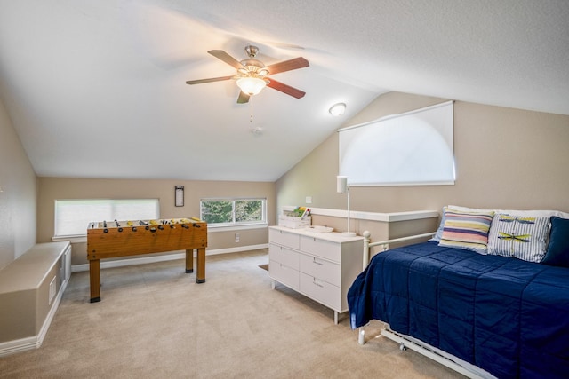 carpeted bedroom featuring a textured ceiling, ceiling fan, and vaulted ceiling