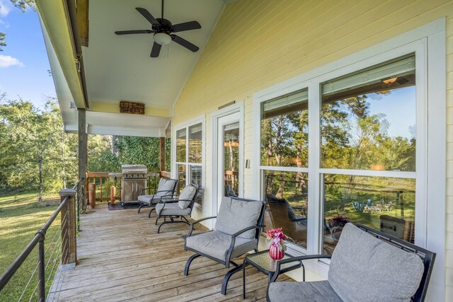 wooden terrace with area for grilling and ceiling fan