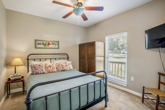 bedroom with ceiling fan and light colored carpet