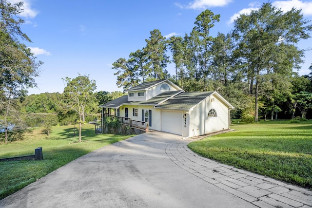 view of front facade featuring covered porch, a garage, and a front lawn