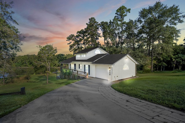 view of front of property with a lawn and a garage