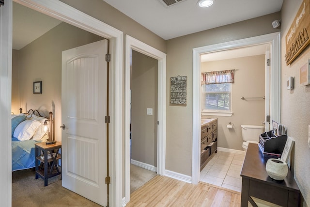 bathroom featuring hardwood / wood-style flooring, vanity, and toilet