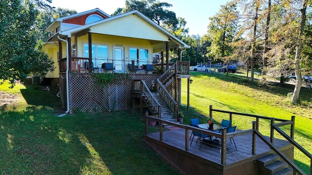 rear view of house featuring covered porch, central AC, a yard, and a deck