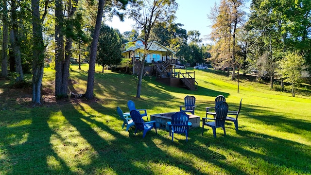 view of property's community featuring a wooden deck and a yard