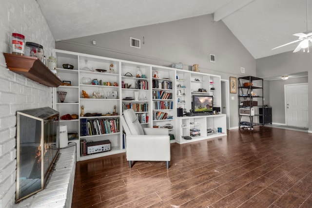 sitting room with ceiling fan, a fireplace, dark hardwood / wood-style floors, and beam ceiling