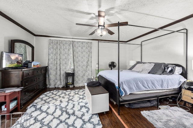 bedroom with ceiling fan, a textured ceiling, crown molding, and dark wood-type flooring