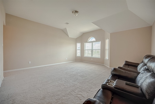 unfurnished living room with light colored carpet and vaulted ceiling