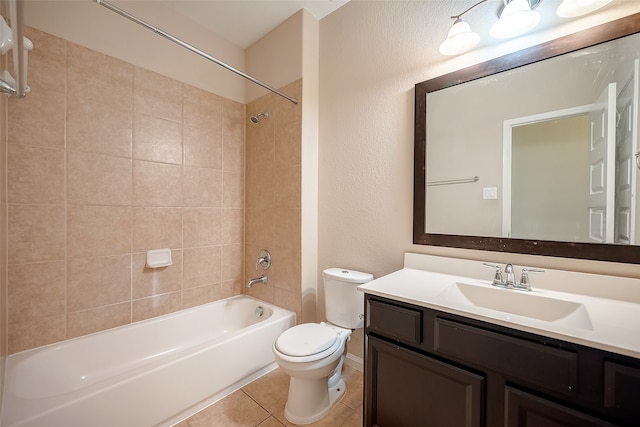 full bathroom with toilet, vanity, tiled shower / bath, and tile patterned flooring