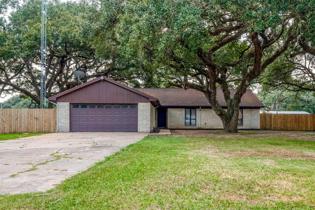 ranch-style house with a garage and a front lawn