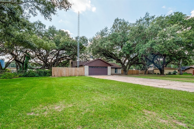 view of front of property featuring a garage and a front lawn