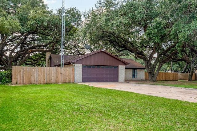 ranch-style home with a garage and a front lawn