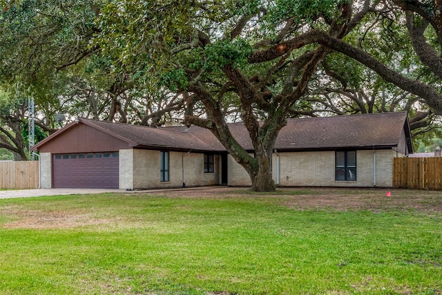 single story home with a garage and a front lawn