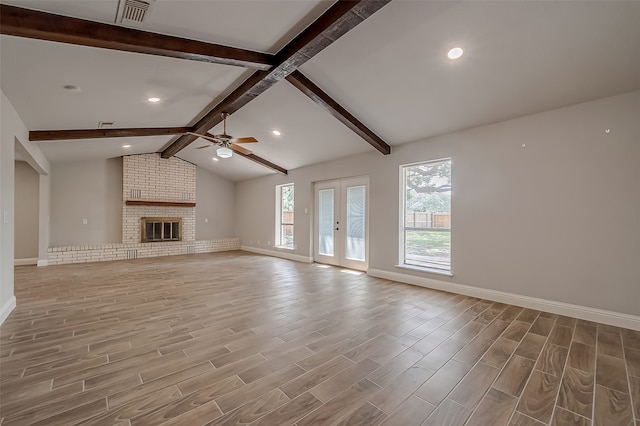 unfurnished living room featuring vaulted ceiling with beams, ceiling fan, hardwood / wood-style flooring, and a fireplace