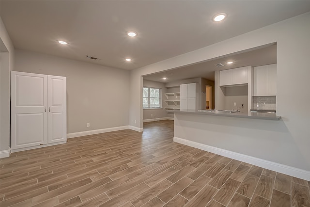 unfurnished living room with light hardwood / wood-style flooring