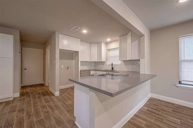 kitchen featuring light wood-type flooring, a healthy amount of sunlight, and white cabinets