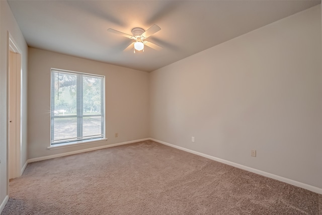 carpeted empty room featuring ceiling fan